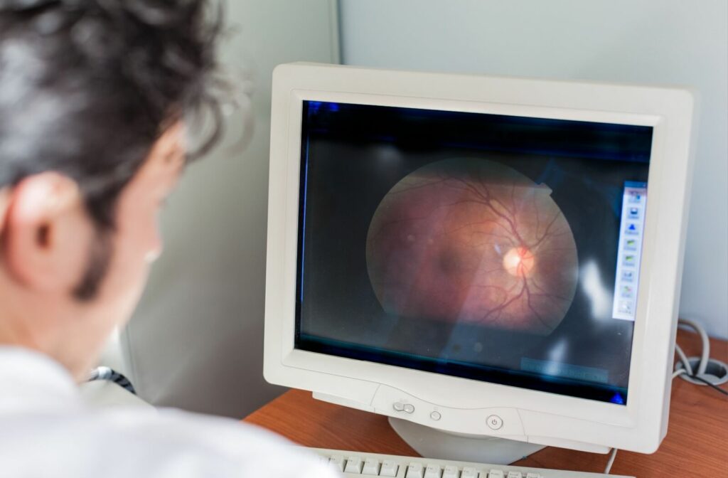 An eye doctor reviews their patient's retinal imaging results.